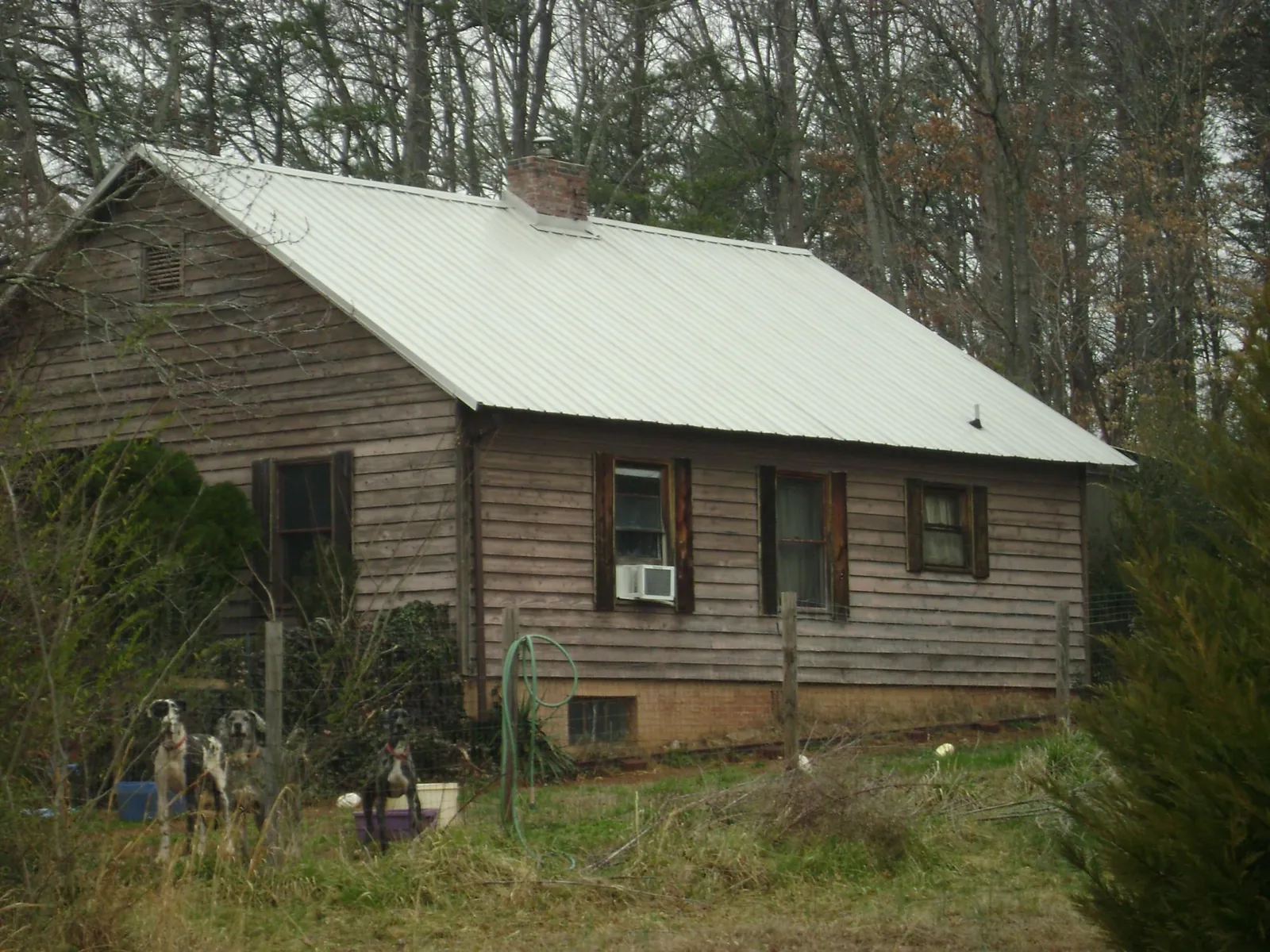 White metal roof on an old wood sided farmhouse, from a Metal Roof Installation job in Afton